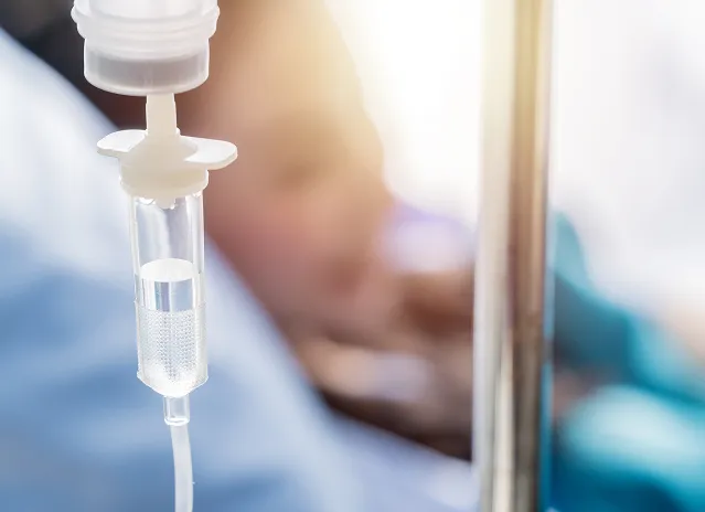IV drip chamber and tubing in a clinical infusion setting