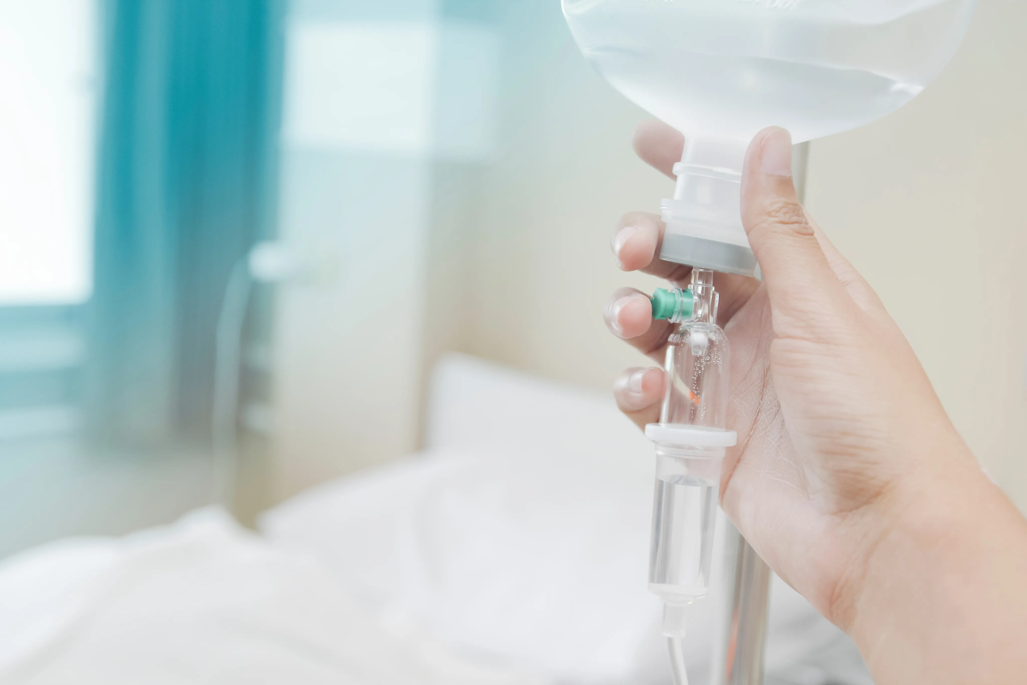 Young woman in white robe receiving IV therapy in modern wellness clinic with spa-like ambiance