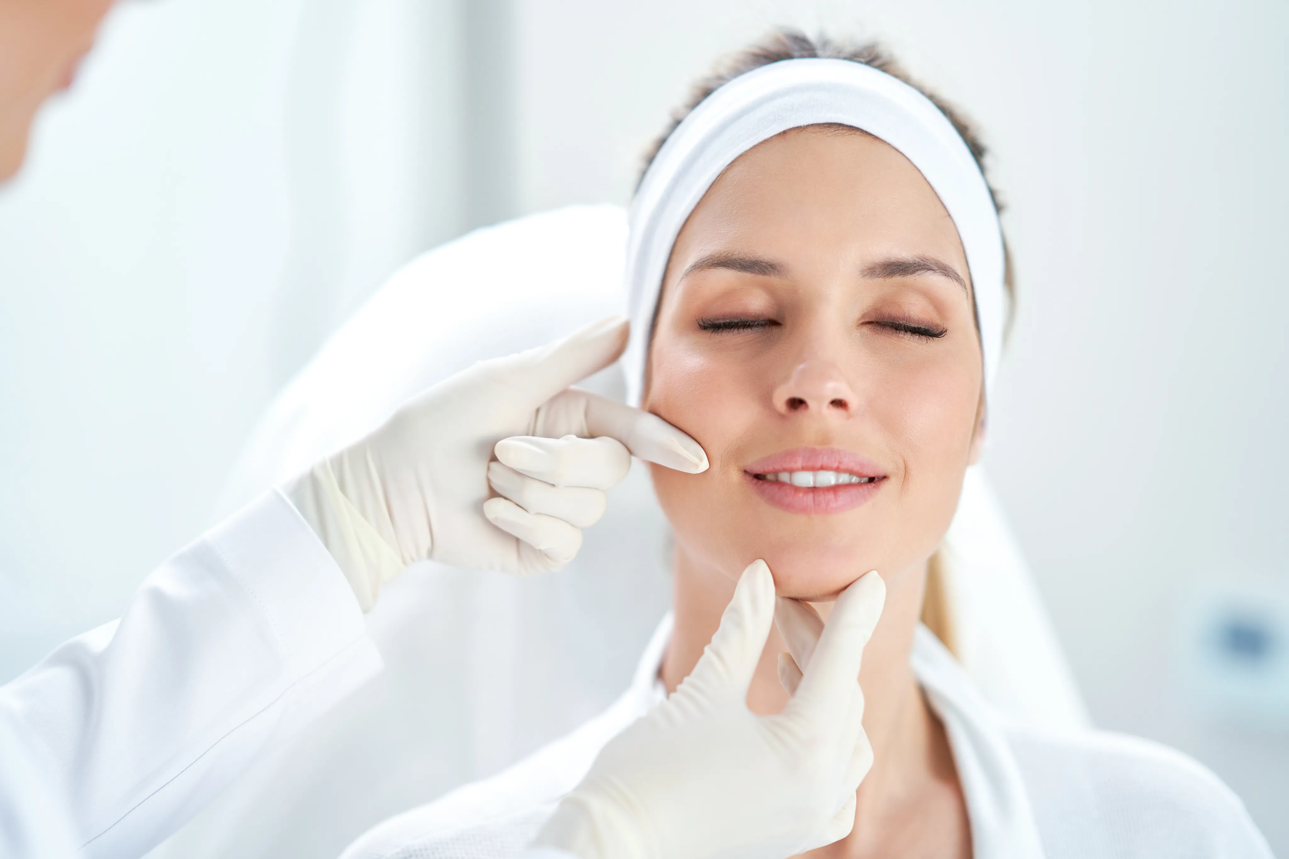Smiling woman with refreshed, enhanced facial features after dermal filler treatment