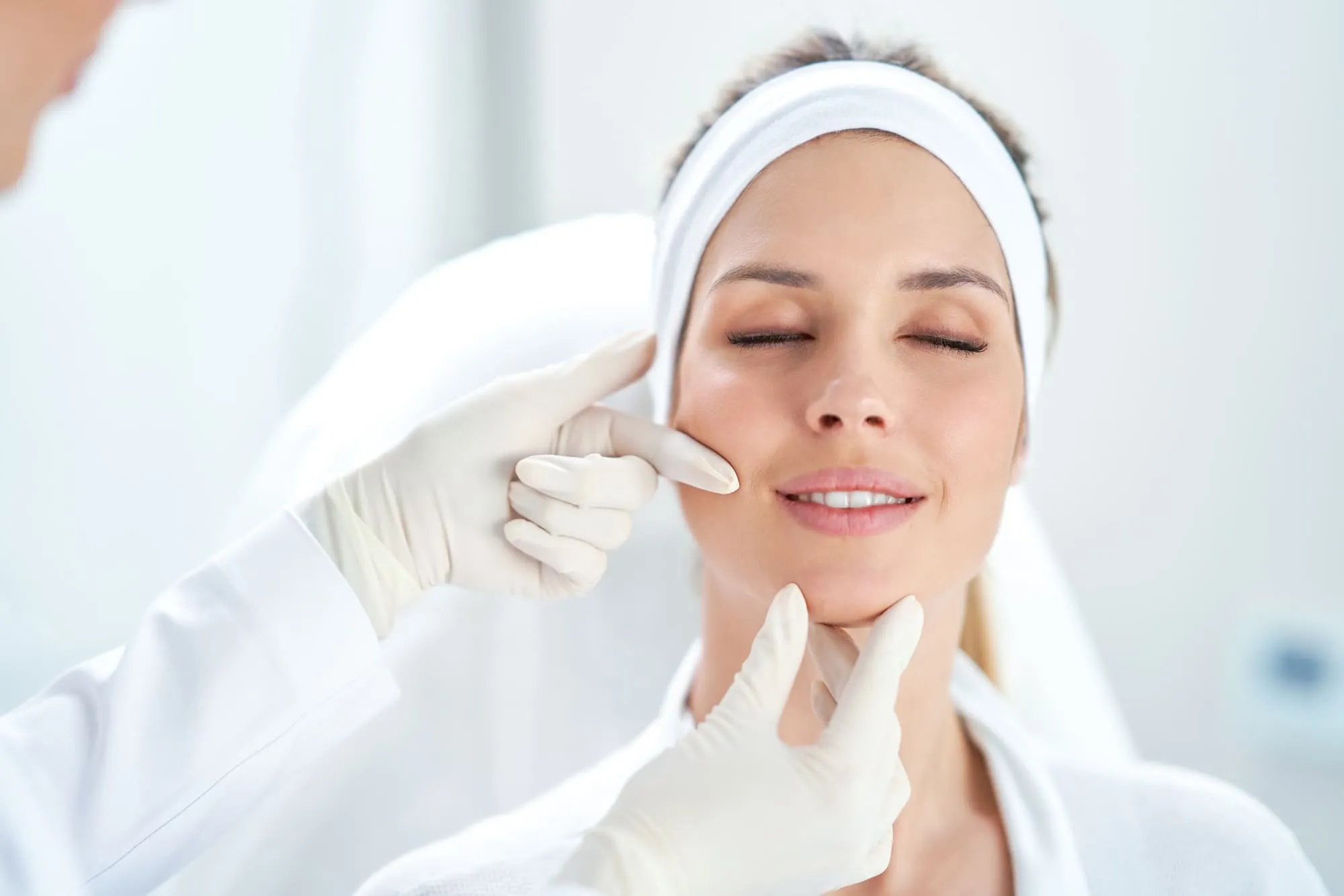 Smiling woman with refreshed, enhanced facial features after dermal filler treatment