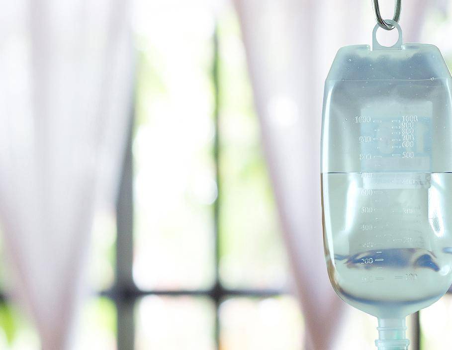 IV infusion bag hanging in a bright clinical treatment room