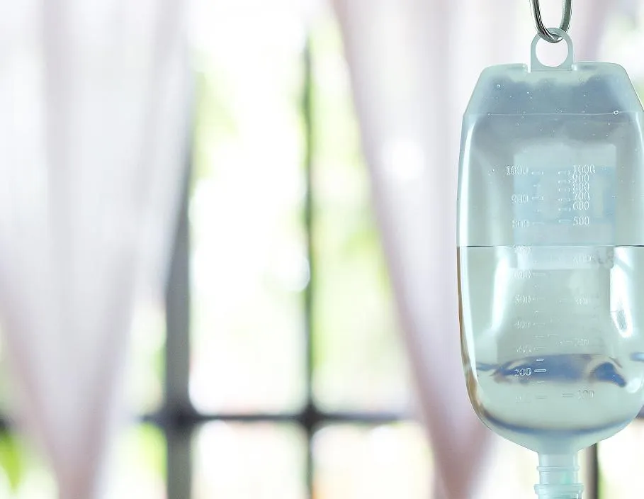 IV infusion bag hanging in a bright clinical treatment room