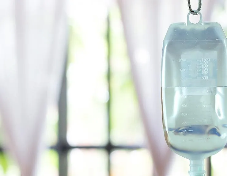 IV infusion bag and tubing in a bright clinical treatment room