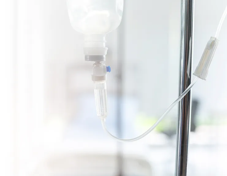 IV infusion bag and tubing in a bright clinical treatment room