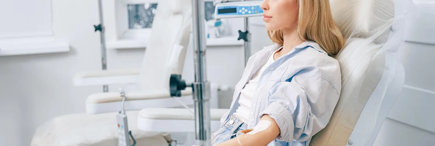 Patient receiving infusion therapy in a bright, modern treatment suite at Citrus Infusion